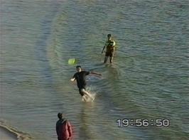 Anthony Long, Paul Smith and Robert Walker play frisbee in the tranquil waters of this unspoiled beach
